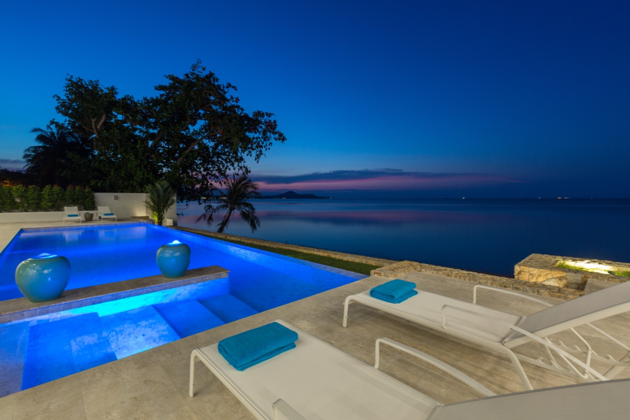 Infinity pool overlooking the sea by night